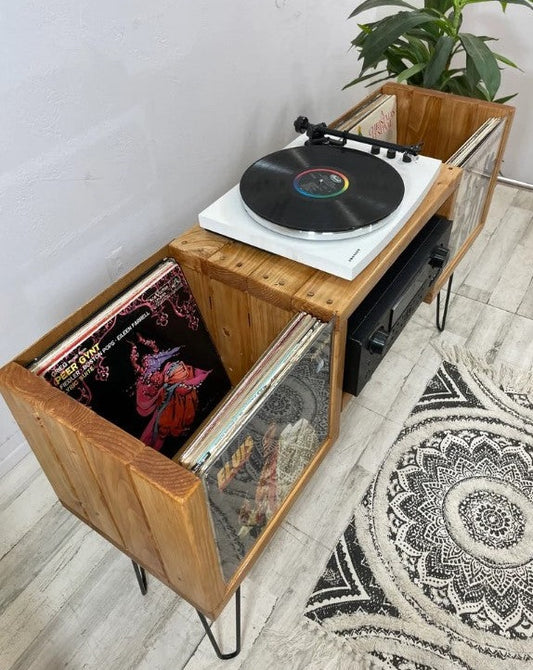 Flip-thru vinyl record storage console with turntable top and open record compartment, light wood frame