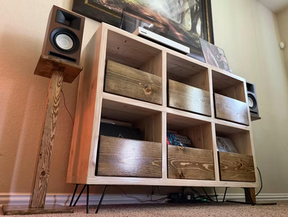 Vinyl record storage cabinet with open compartments and wooden drawer fronts