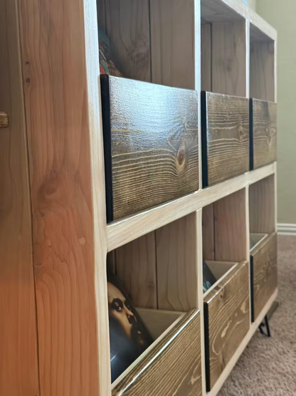 Wood and white vinyl record storage cabinet corner with drawer doors and open shelves