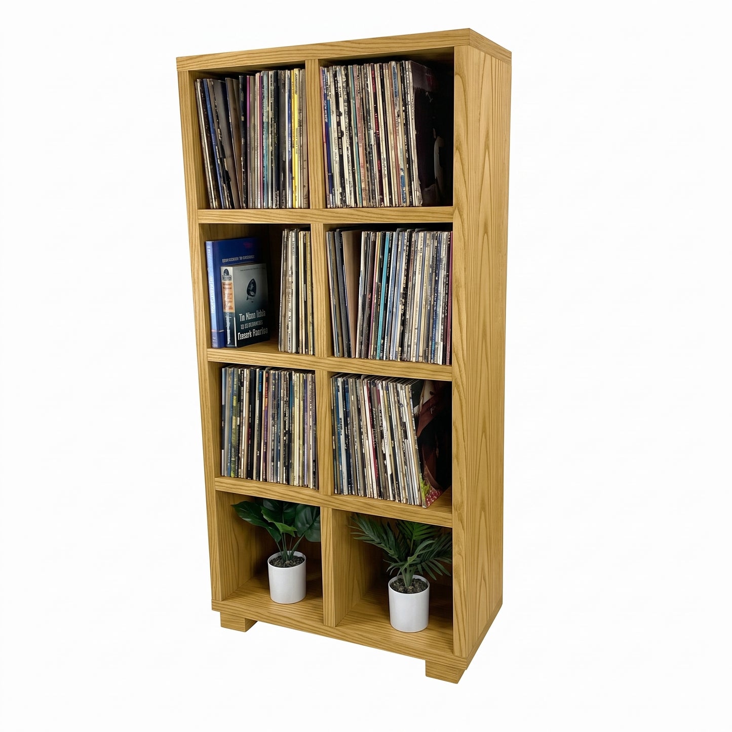 Light wood vinyl record storage cabinet with open cubbies and stacked records