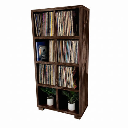 Dark wood vinyl record storage cabinet with open cubbies and vinyl records inside