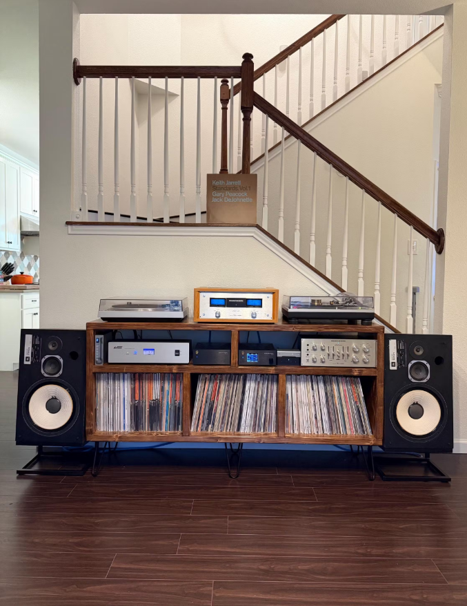 Wooden Cabinet Storing the following equipment: JBL 100 Century SpeakersMarantz Power Amp StandWAudio AC Noise Power ConditionerEVO Compact Fully-Balanced High-Power Stereo/Mono Power Amplifier MM/MC Phono PreampWiiM Pro and DACMarantz Pre AmpTechnics Turntable