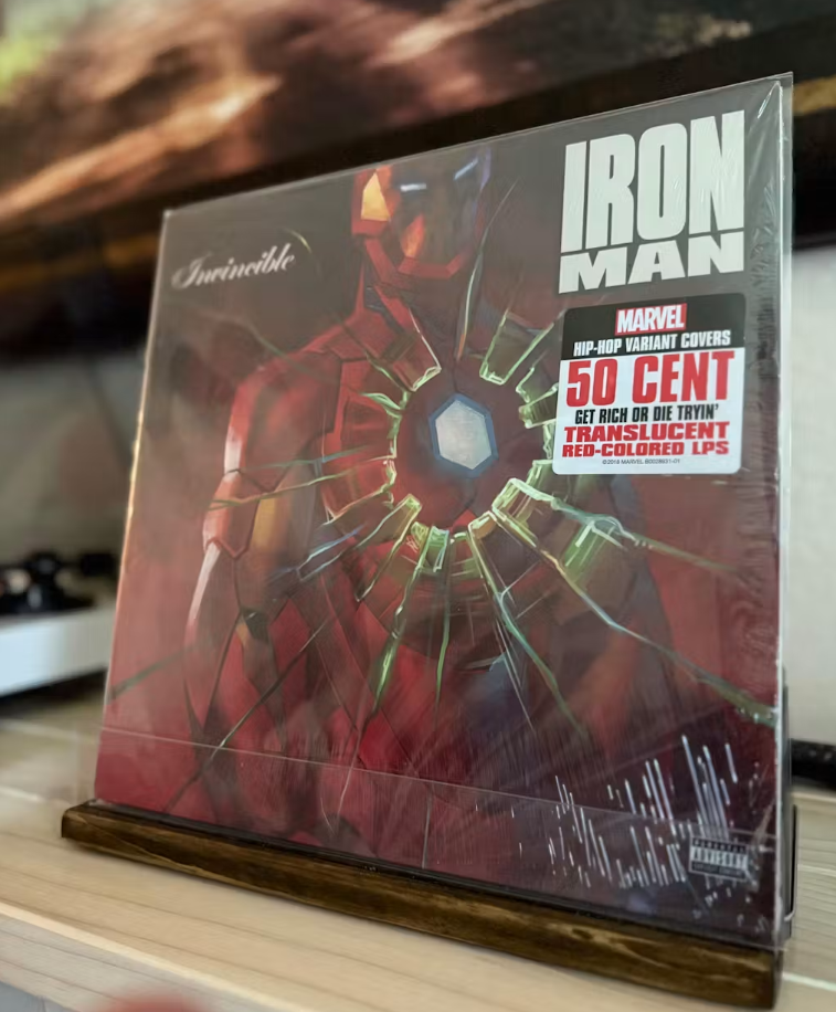 Wood record shelf with clear acrylic lip holding a record cover upright, front view