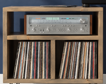 Wood media console with stereo receiver front panel, knobs, and buttons