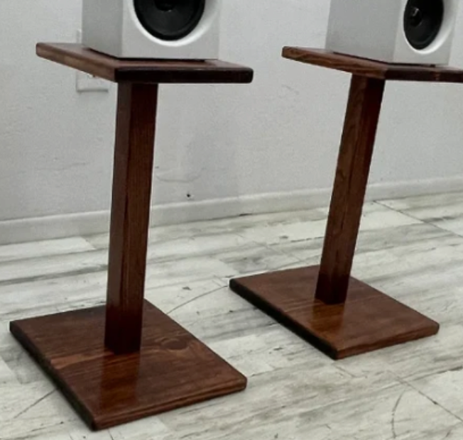Pair of wooden speaker stands with square bases and tapered posts
