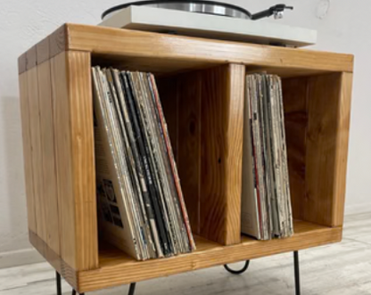 Wooden record storage rack with open front compartments and slanted magazine holders
