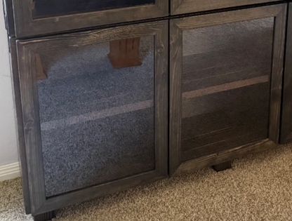 Dark wood cabinet with two glass doors and fabric-lined interior