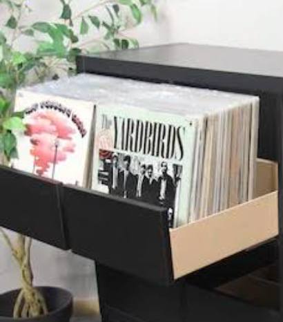 Black wall shelf with open compartments and a decorative front panel