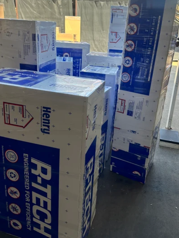 Stack of shipping cartons with blue tape and RT-TECH labels