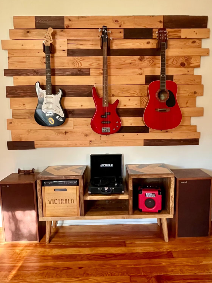 Wooden wall with guitars and a record player setup